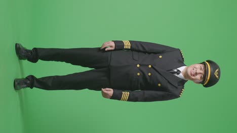 full body of asian man pilot standing and smiling to camera in the green screen background studio