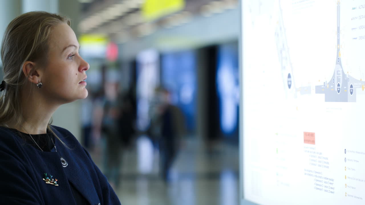 Woman looking at schematic map in the airport