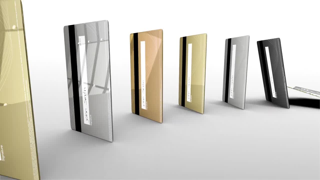 금과 은의 신용카드가  ⁇  배경에 도미노처럼 원으로 떨어지고 있습니다.