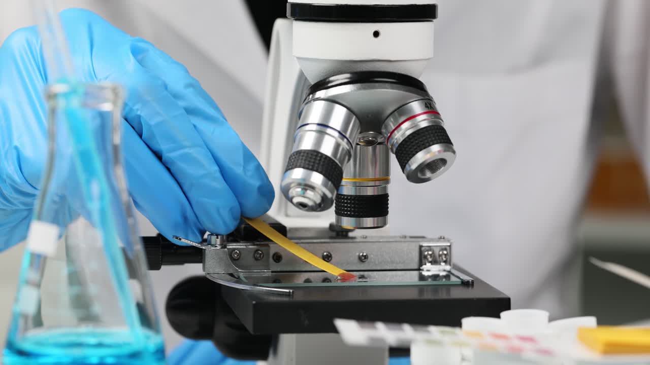 Close-up of a scientist using a microscope in a laboratory