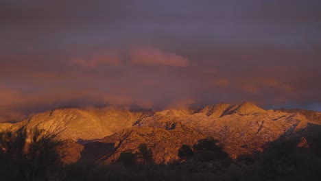 beautiful pink and orange sunset light on snow covered mountains, arizona