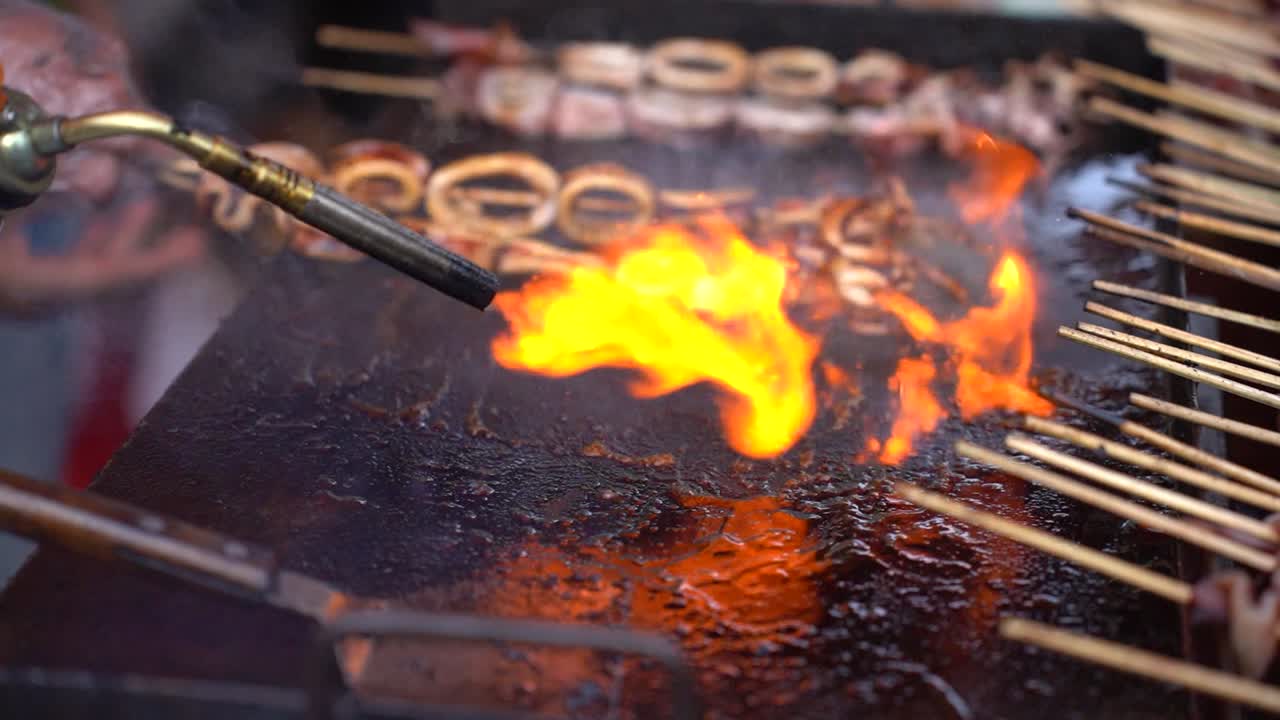 Sate squid when the process is burned. Grilled squid on skewers, Good street food in night market or ramadhan market.