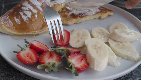 delicious pancakes with strawberries and banana