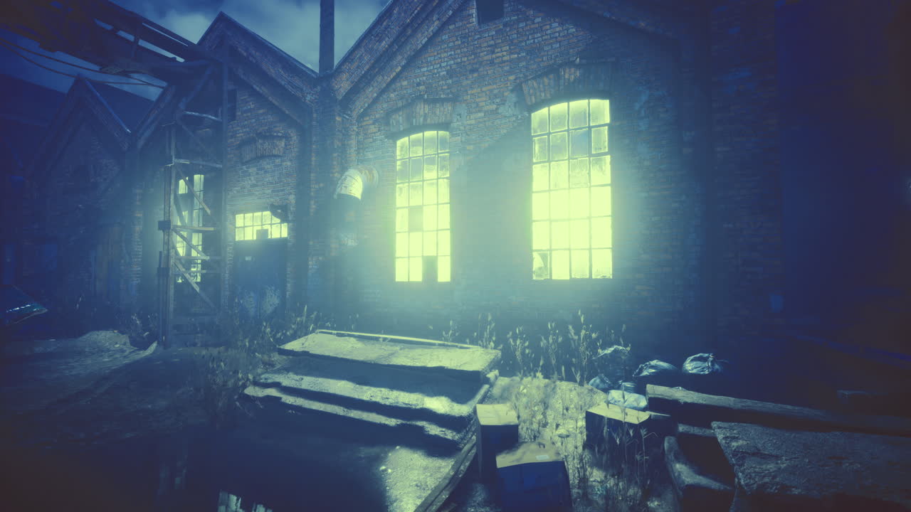 Abandoned industrial building with glowing windows at twilight
