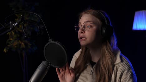 woman recording podcast in home studio