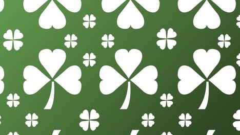 animation of multiple white clover leaves moving on green background