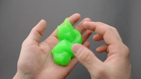 slippery green slime touches by person, pov slow motion