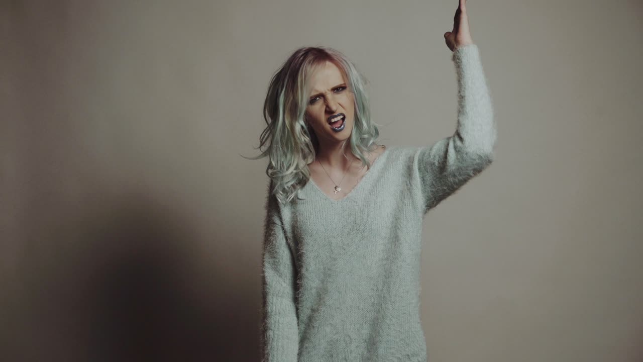 Colourful Studio Shot of Funny Model Girl. Beauty woman portrait with colorful makeup and hair
