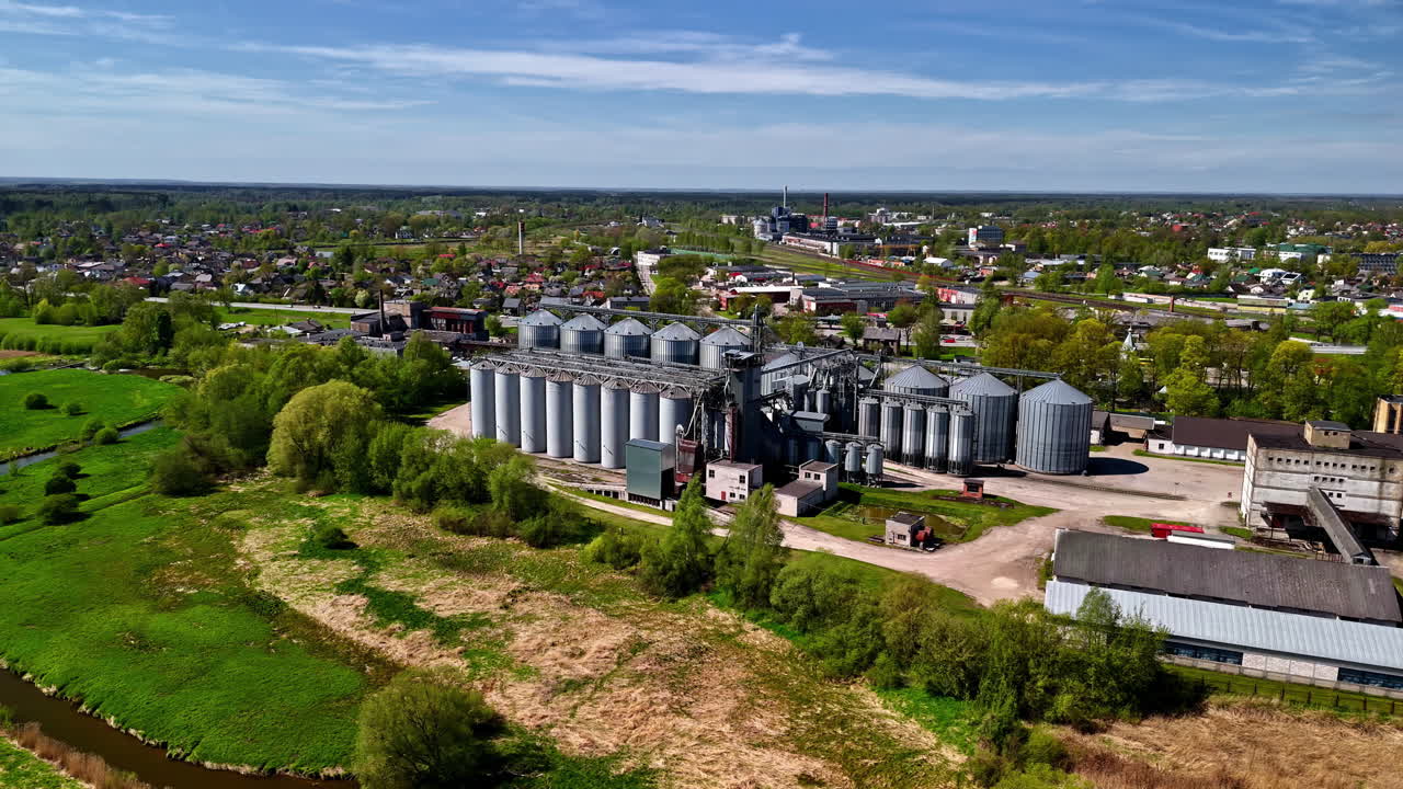 Metal processing vats at industrial complex with conveyor systems, topdown flyover