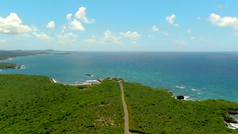 aerial tilt up revealing coastal landscape with puerto ferro light in background