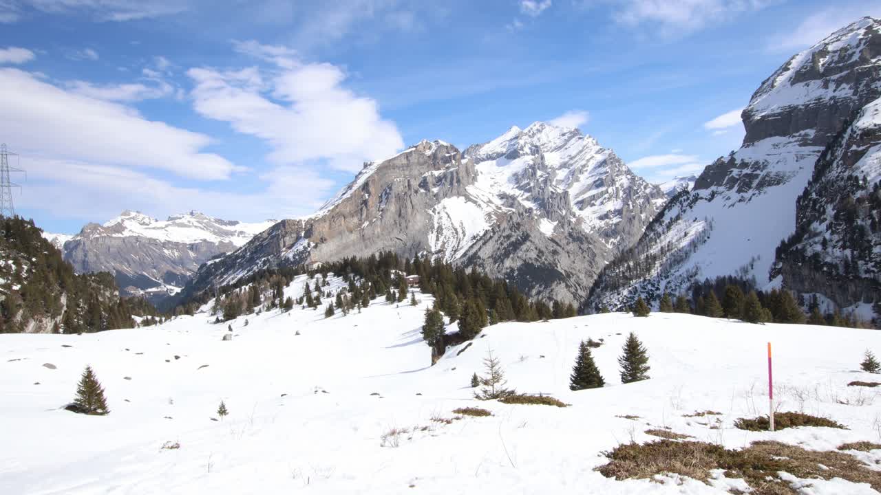 Low snow levels in Swiss alps, wide mountain landscape