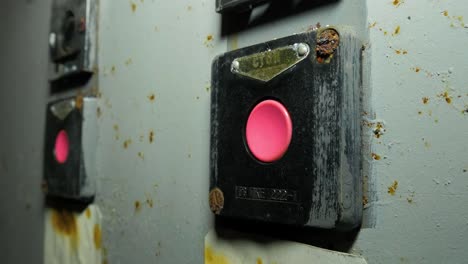 Old-red-electricity-switch-inside-the-abandoned-Soviet-underground-bomb-shelter,-old-Soviet-Cold-war-bunker,-apocalypse,-handheld-close-up-shot