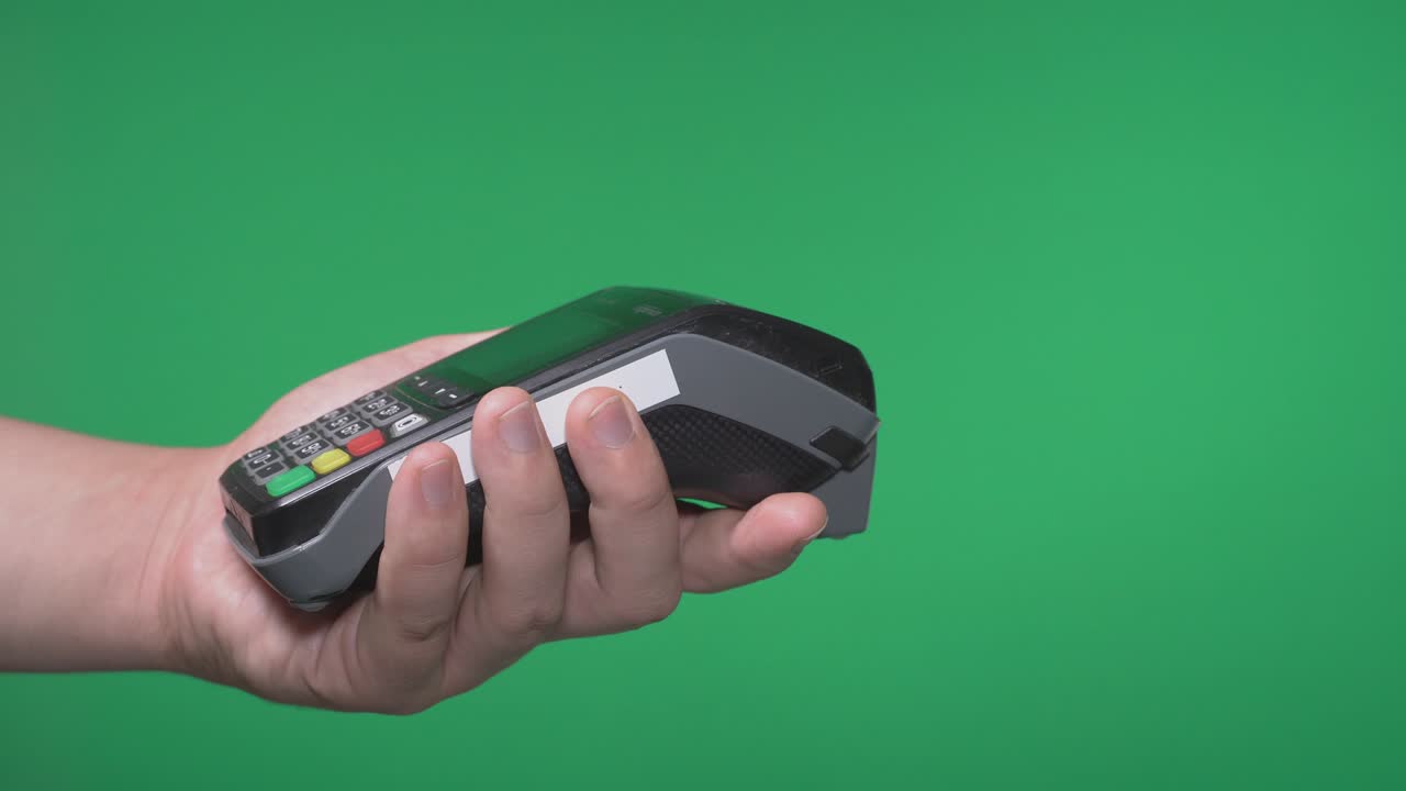 Close up male hold in hand wireless modern bank payment terminal to process acquire credit card payments black card isolated on green screen. Copy space mock up advertising, girl pay