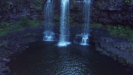 drone rising up to reveal a waterfall in wales