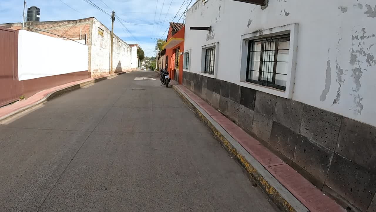 Casual Walk Along a Colonial Pathway in a Busy Mexican Village