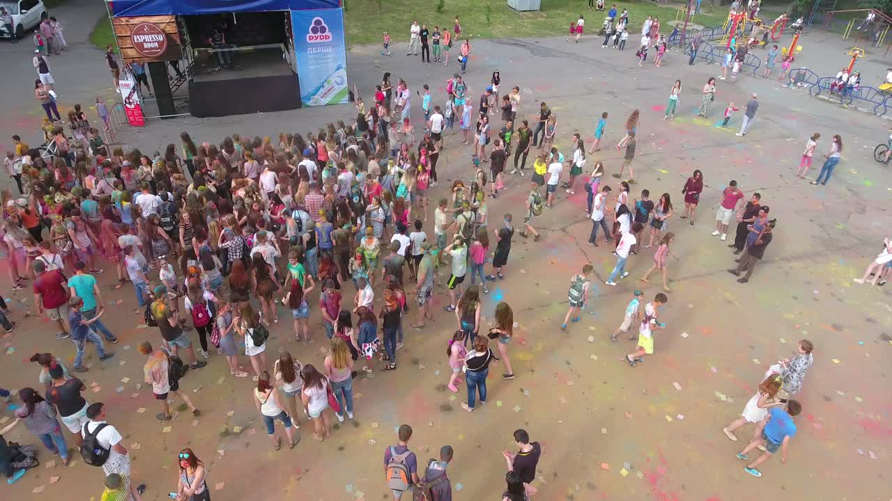People Celebrating Festival Of Colors. VINNITSA, UKRAINE - JULY 2017: Young people at holi party covered with color powder