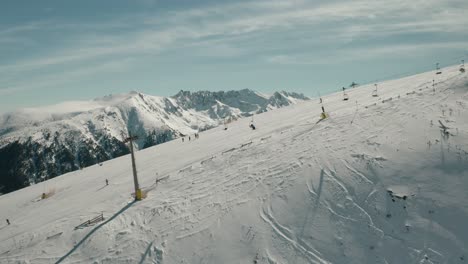 Ski-Chairlift-on-Snow-Mountain-Slope-in-French-Alps-Mountains,-Aerial