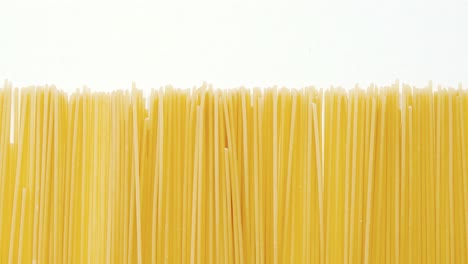 Raw-spaghetti-arranged-on-white-background