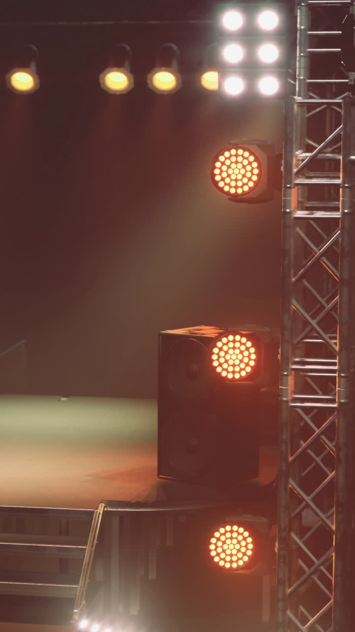 Lights and sound setup for a stage event in a large venue at night