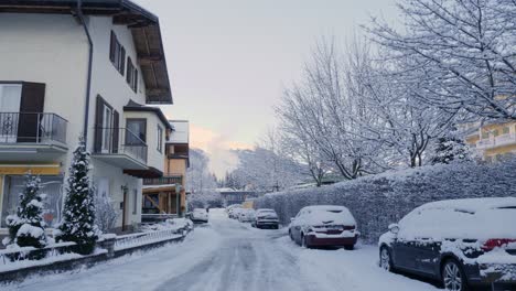 life during extreme winters in the alps with snow covered houses, roads and cars