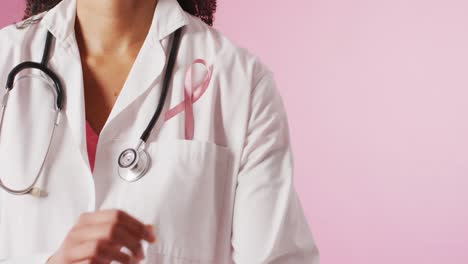 Video-of-biracial-female-doctor-with-pink-breast-cancer-ribbon