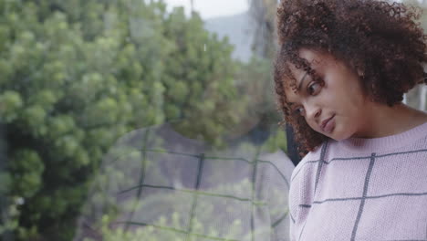 looking out window, woman in casual wear reflecting, thinking deeply, copy space