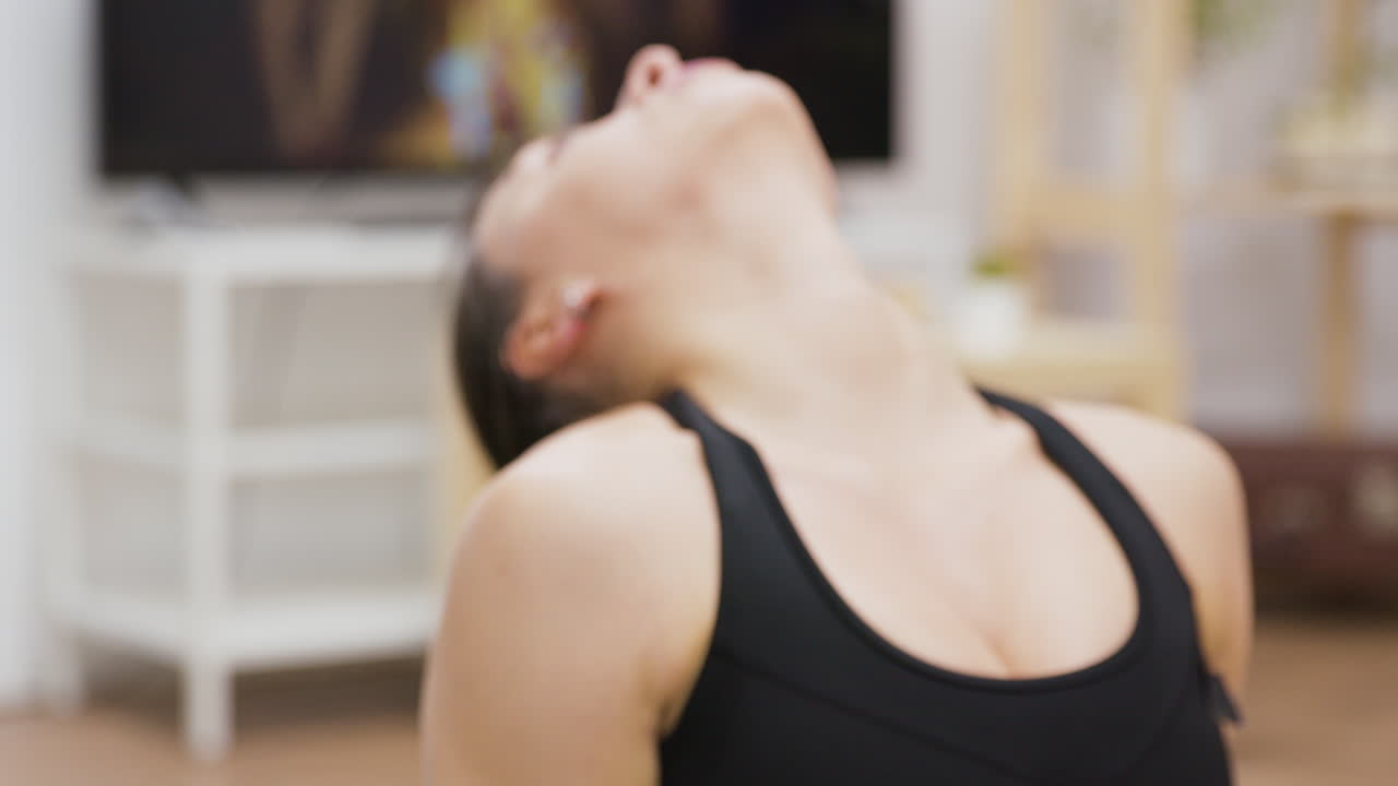 Woman stretching her neck indoors
