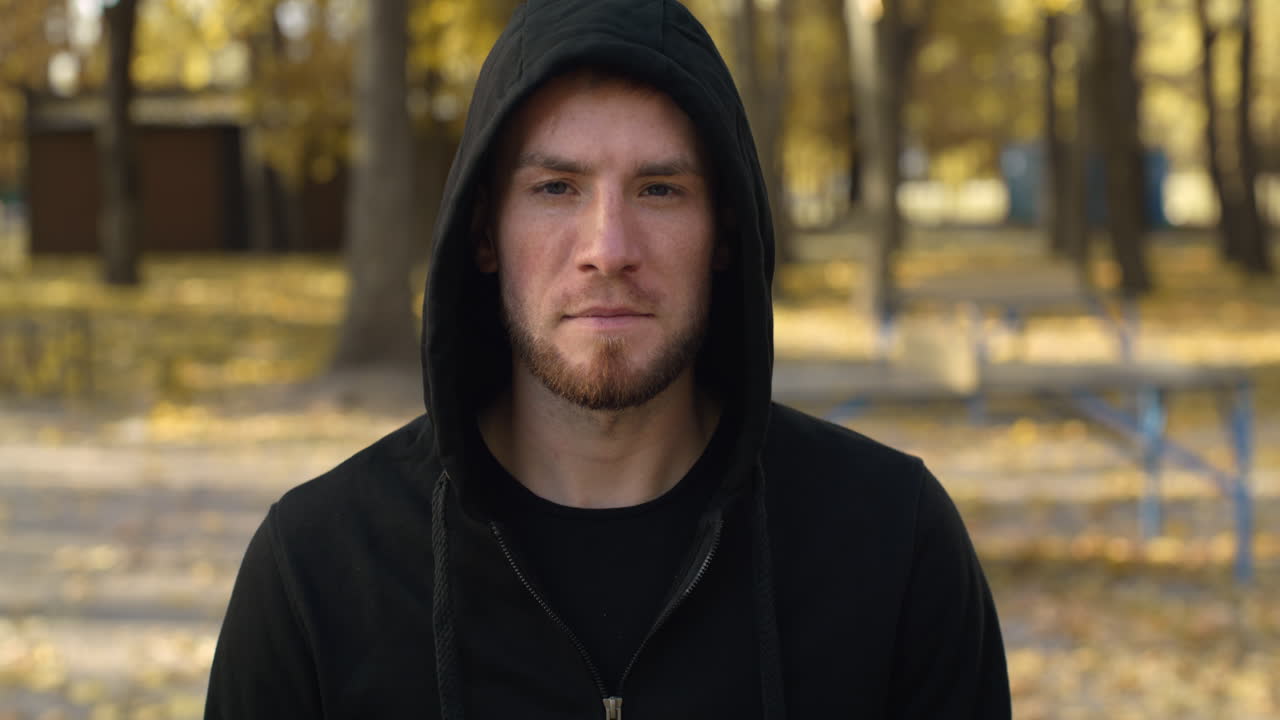 Man in a Hoodie in Autumn Park