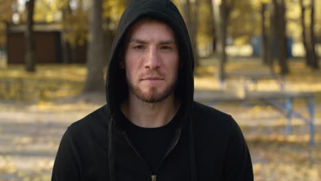 man in a hoodie in autumn park