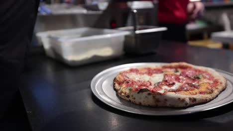 small pizza in kitchen ready to be taken to the customer