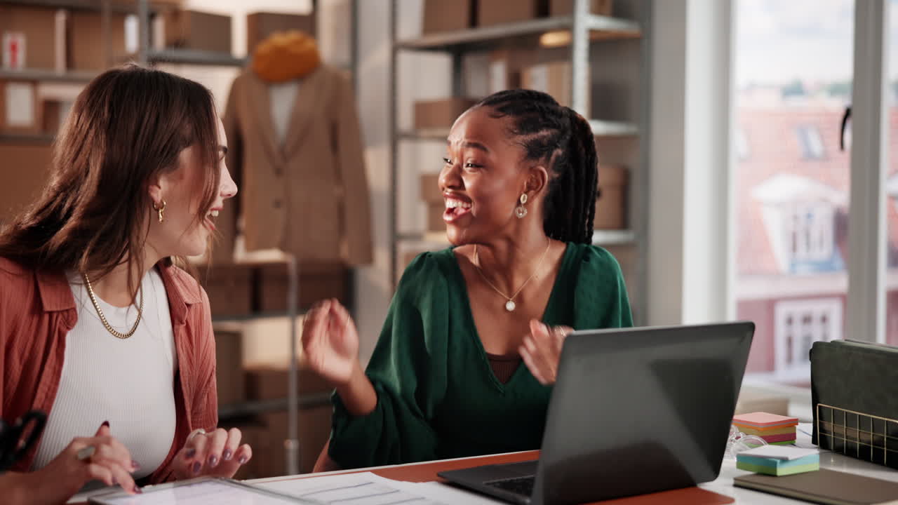 Two Diverse Businesswomen Celebrate Success Working on Laptop in Office