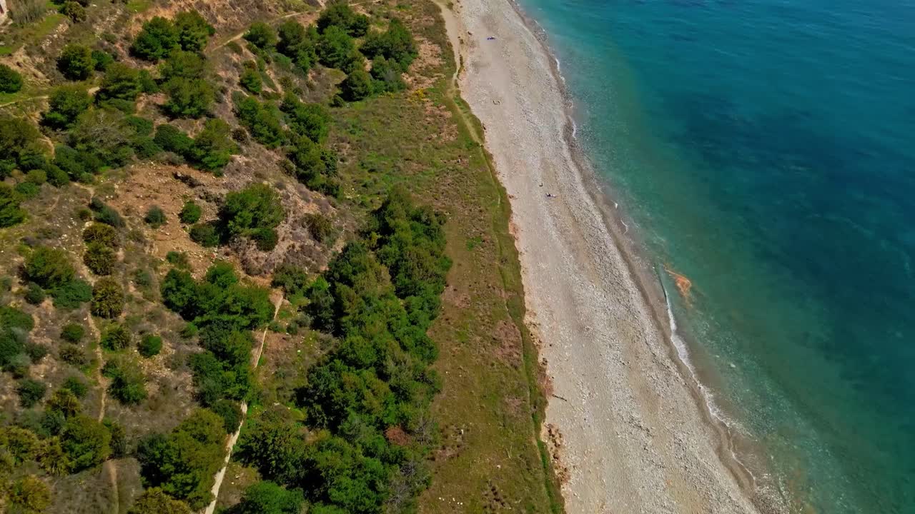 Drone moving forward and tilting up into the horizon at the coast of Nerja, south of Spain