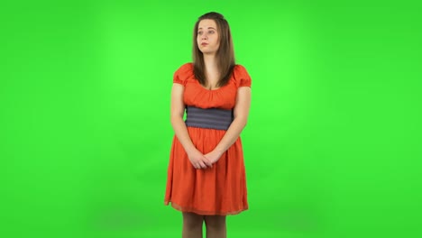 woman in orange dress on green screen