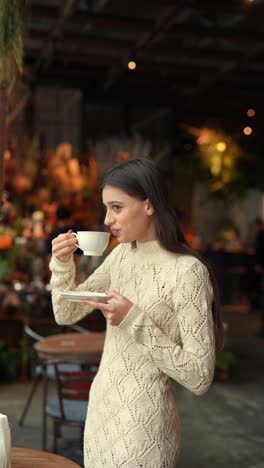 woman enjoying a drink in a cafe