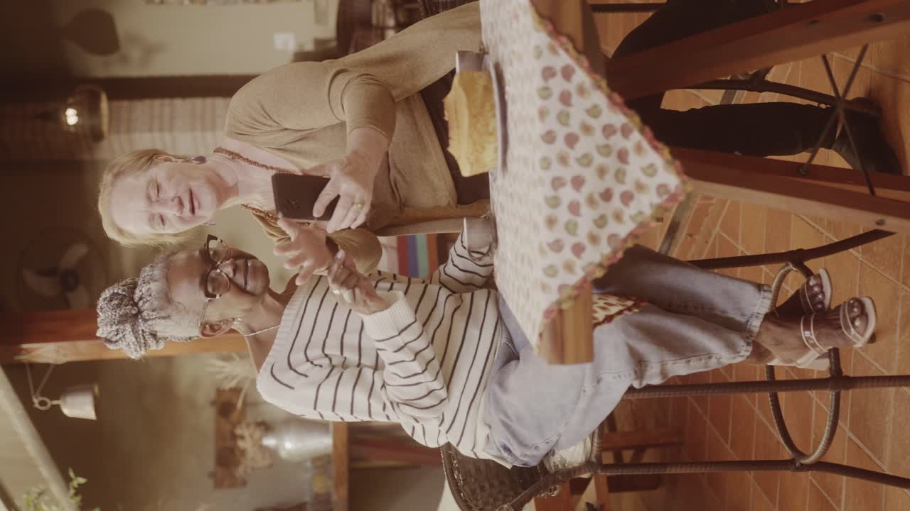 Two Elderly Women Sharing a Moment with a Smartphone