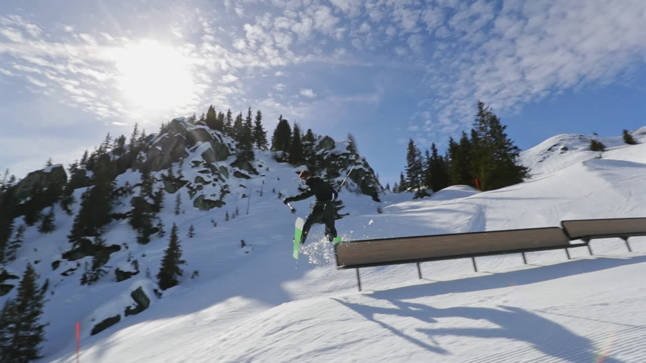 Dynamic freestyle skier throwing big airs and stylish tricks on rails at Laax Snowpark, Switzerland—capturing high-level performance, style, and action in a world-class winter setting.