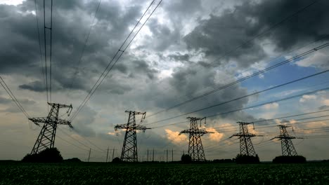 time lapse of high voltage power line and five electricity pylons.