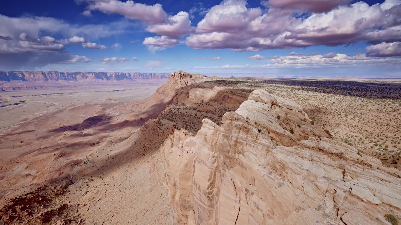 Breathtaking drone shot soaring along the rugged mountain ridge, capturing the steep descent near Antelope Pass Vista on Highway 89 toward Page, Arizona.
