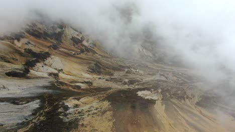 steam and cloud rising over striped volcanic rock in the colombian andes