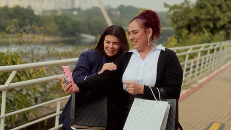 Two Women Taking Selfies and Enjoying a Shopping Day Outdoors