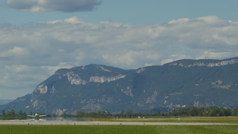 airplane taking off near mountains