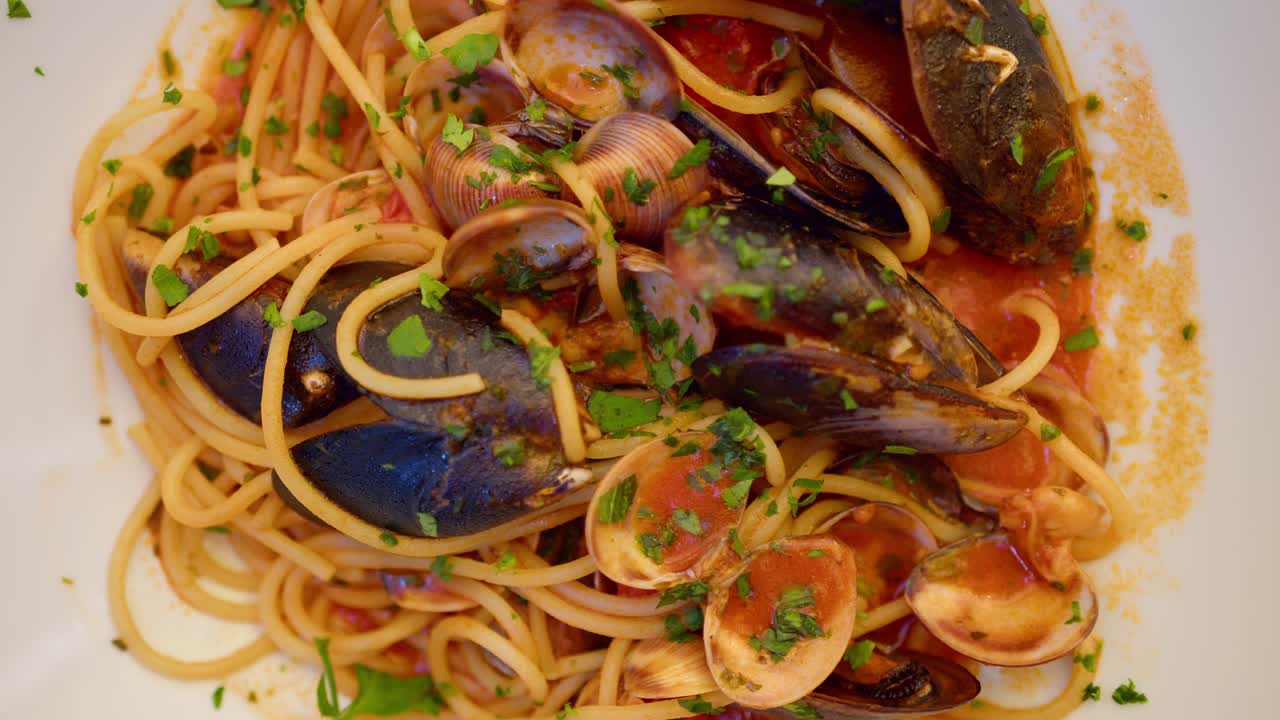 Top shot of Spaghetti allo Scoglio, seafood pasta elegantly arranged on a plate in Sicily, Italy