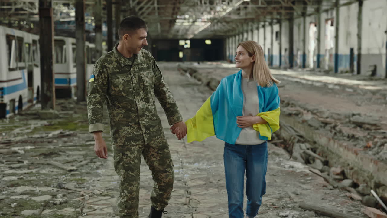 Ukrainian Soldier and Civilian in a War-Torn Factory