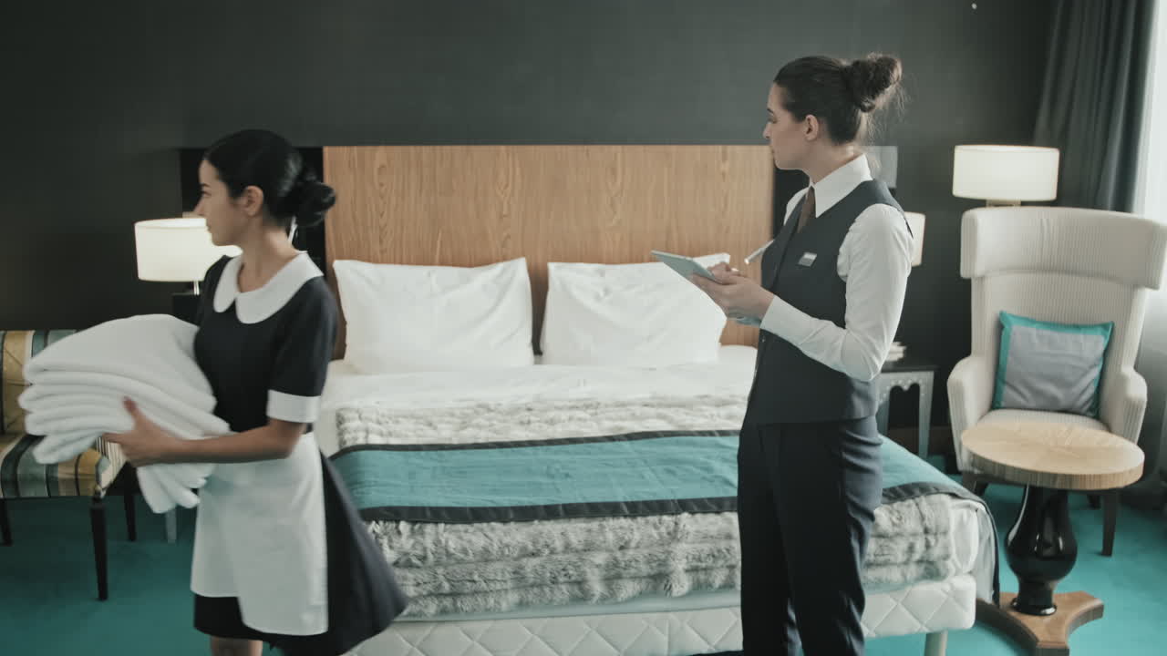 Staff Preparing Hotel Room for Guest