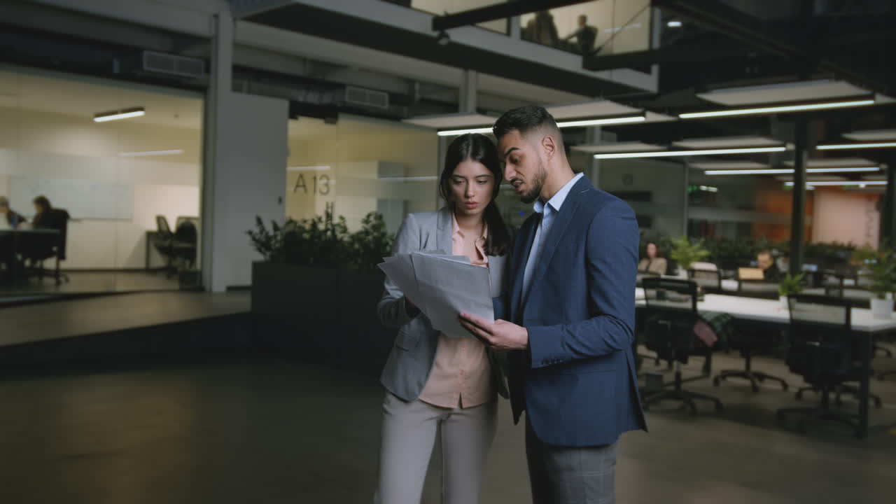 Business colleagues discussing documents in a modern office
