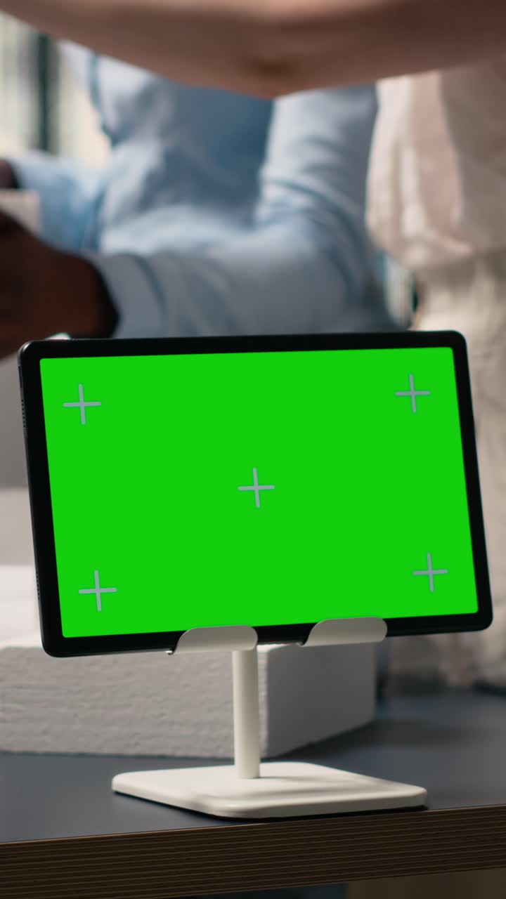 Vertical Video Real estate developers work together using architectural models and copy space