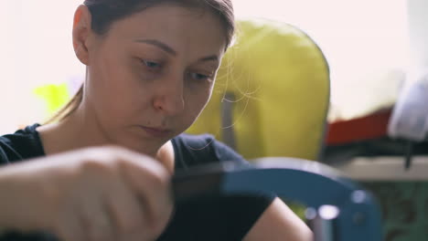 Serious-woman-works-with-special-metal-press-machine