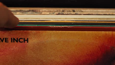 close up man hands browsing vintage vinyl records at home