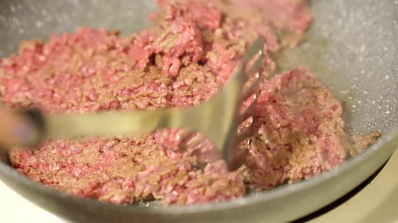 Sizzling Minced Meat in a Frying Pan with Spatula During Dinner Prep