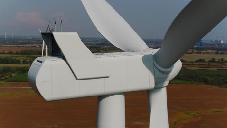 Wind-Turbines-with-an-Aerial-Panning-Shot-Inspection-Close-Up-with-Farmland-in-the-Background